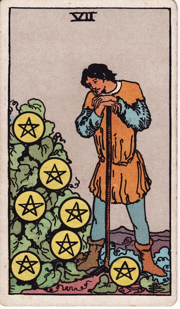 Seven of Pentacles tarot card from the classic deck, illustrated by Pamela Colman Smith in 1909