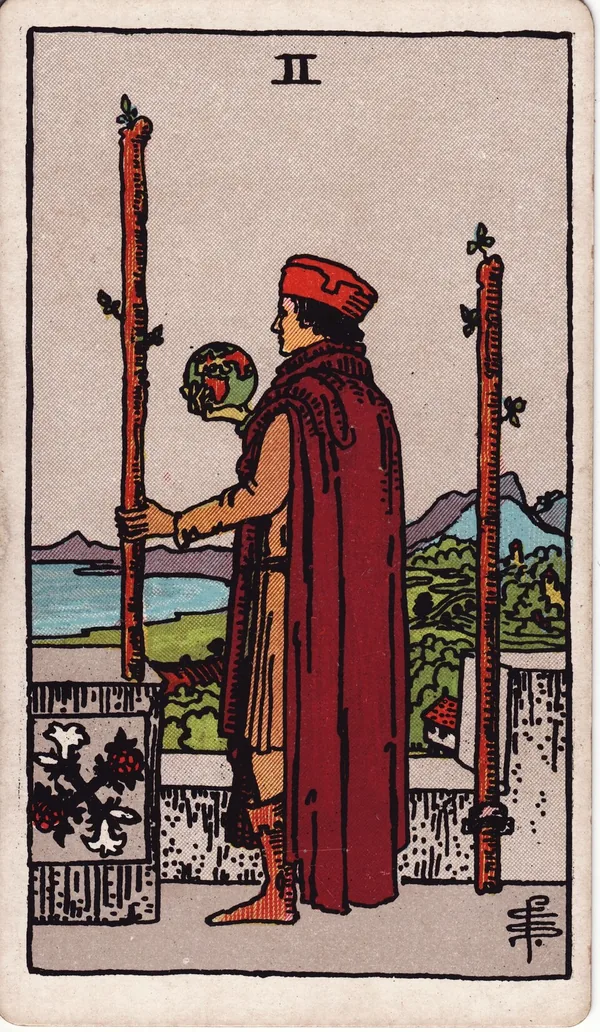 Two of Wands tarot card from the classic deck, illustrated by Pamela Colman Smith in 1909